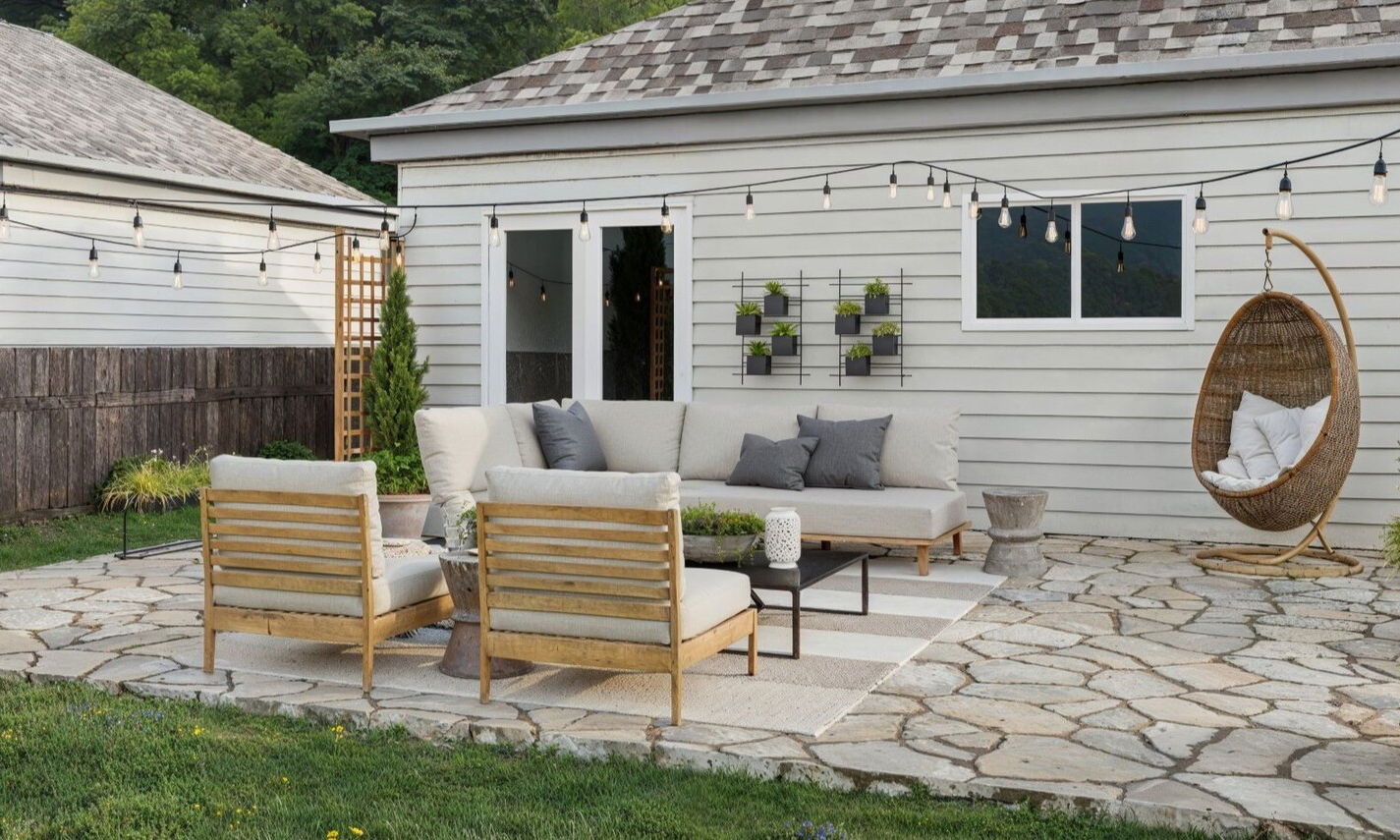 Flagstone Patio Design with Strung Lights by interior designers in San Antonio, Texas