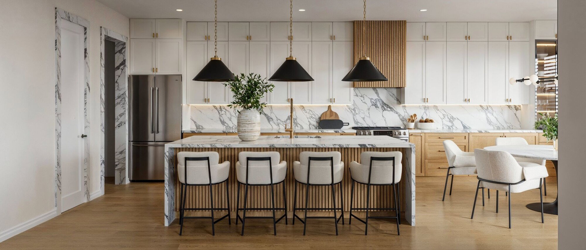 Modern Minimalist Kitchen with Marble Accents by interior designers in Port St. Lucie, Florida