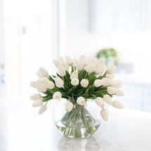 Online Designer Combined Living/Dining Five Dozen Real Touch Faux Tulips Arranged in a Clear Glass Bubble Vase Set in Water Illusion. 