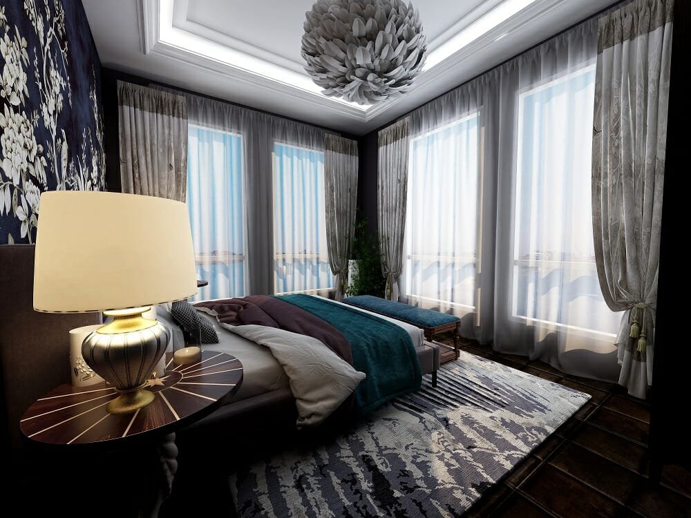 Luxurious glam bedroom with floor to ceiling drapes and teal accents by online interior designer Kassondra Leigh