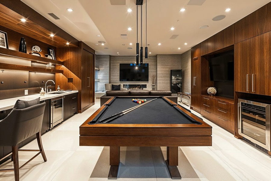Basement room design with a game table by Decorilla